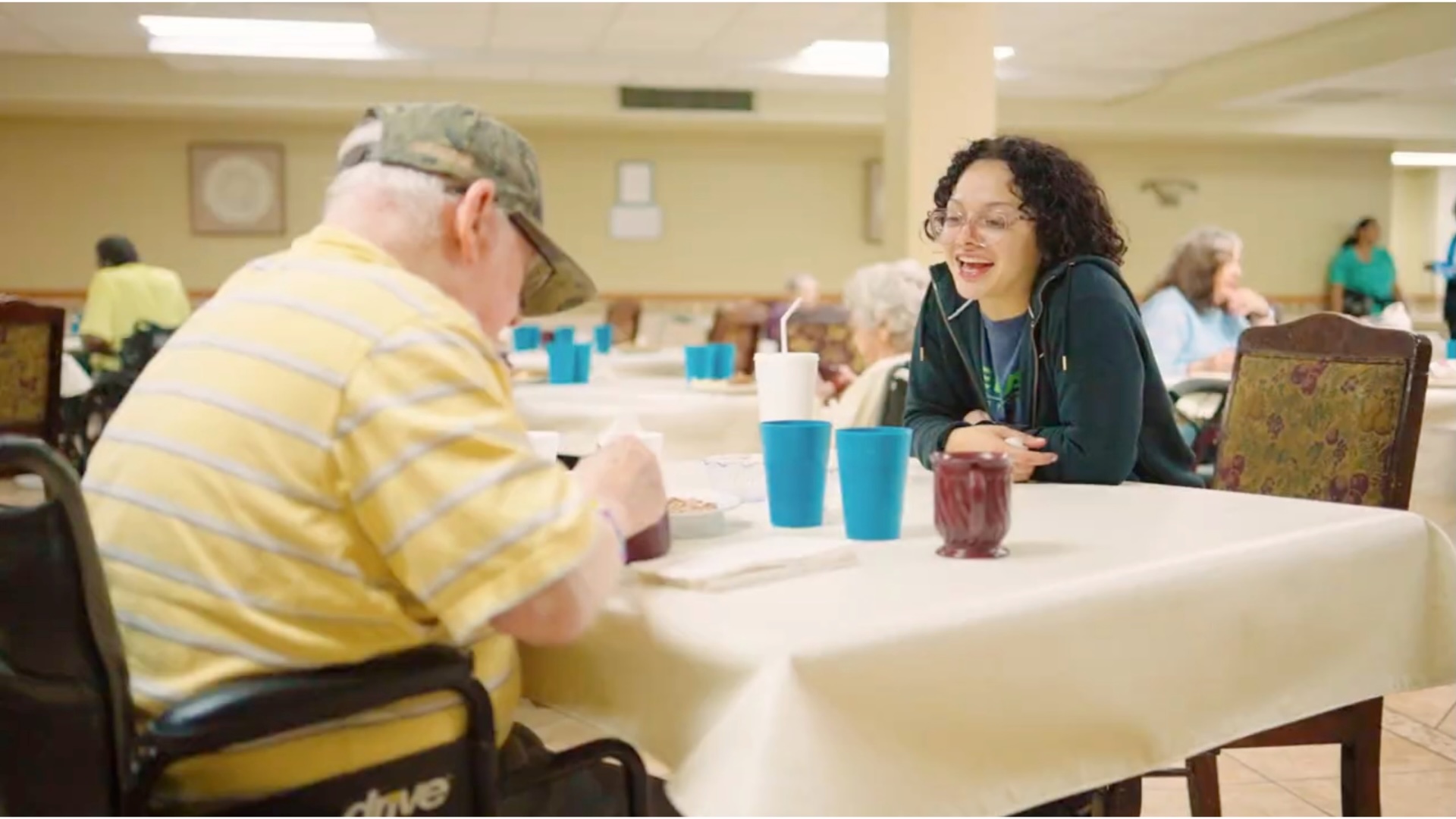 caregiver-chatting-with-resident-wheelchair-cedar-woods-assisted-living