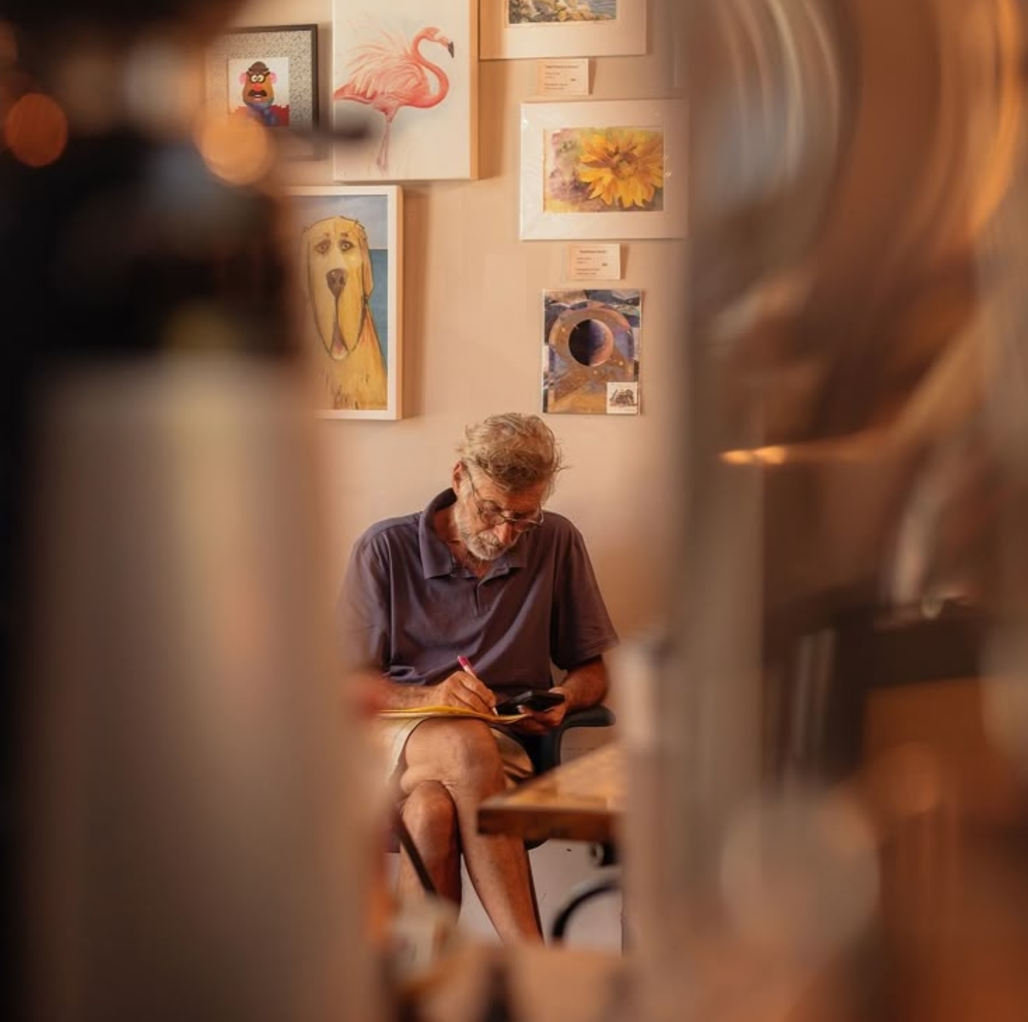 Resident enjoying a quiet moment in a shared common area at Cedar Woods Assisted Living in Belleville, MI
