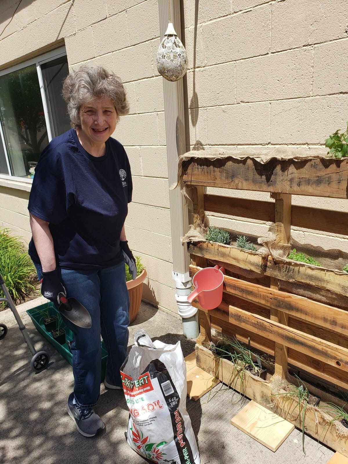 Resident gardening outdoors at Cedar Woods Assisted Living in Belleville, Michigan