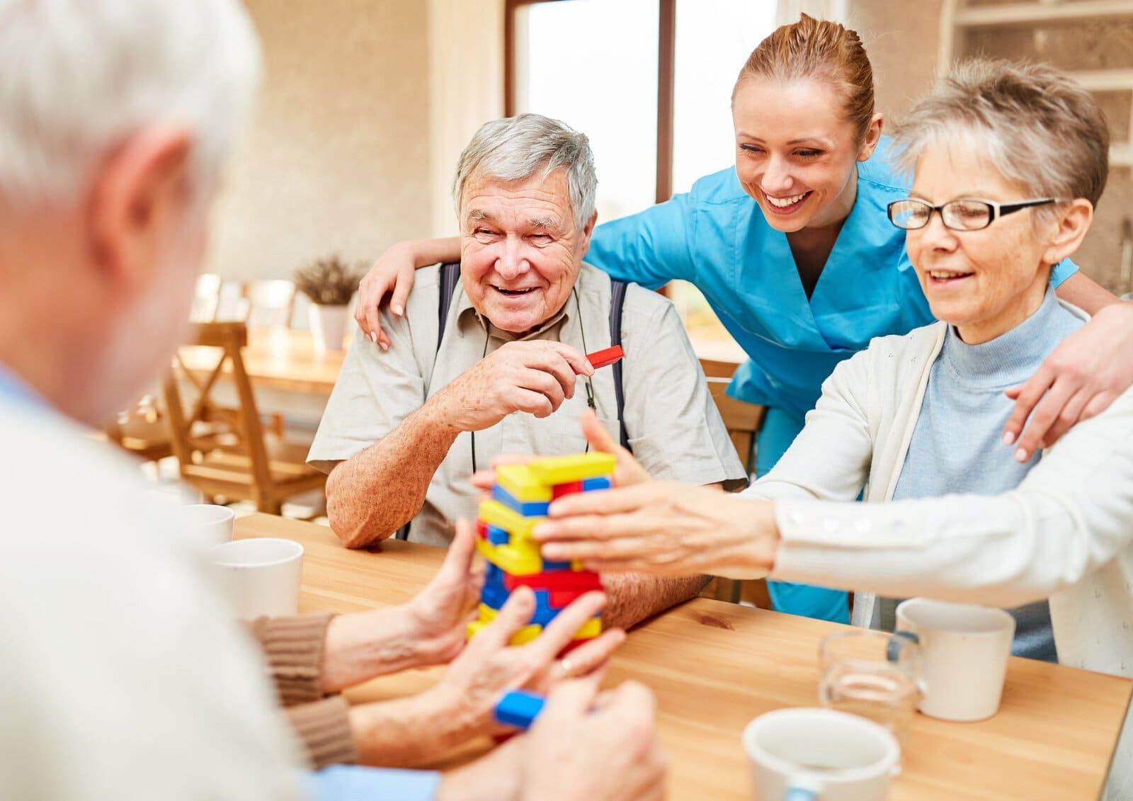Residents enjoying a group activity with personalized support at Cedar Woods Assisted Living and Memory Care in Belleville, Michigan