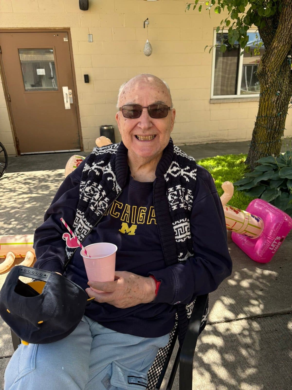 Smiling resident enjoying an outdoor activity at Cedar Woods Assisted Living and Memory Care in Belleville, Michigan