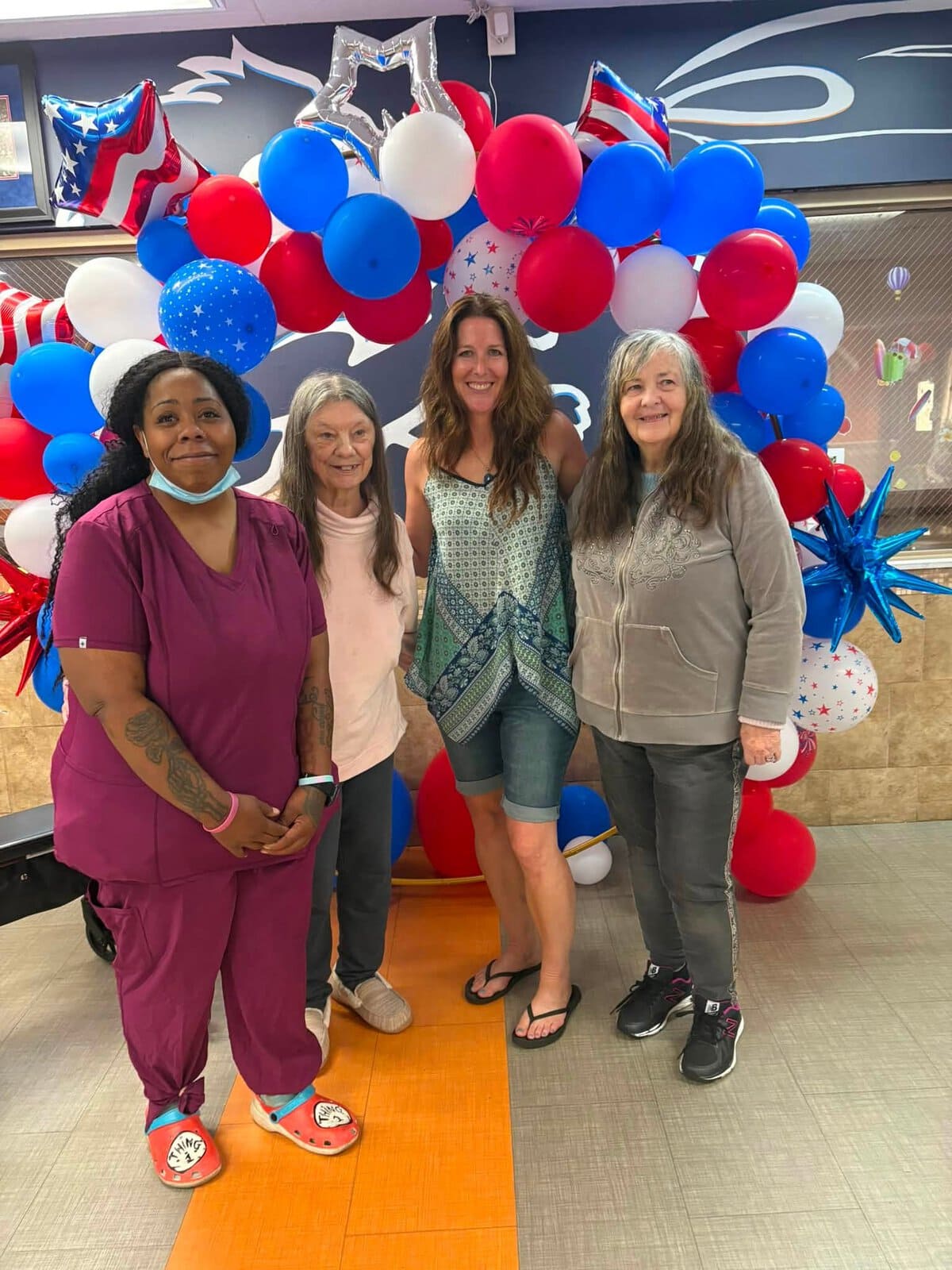 Residents and staff celebrating a football-themed community event at Cedar Woods Assisted Living and Memory Care in Belleville, Michigan