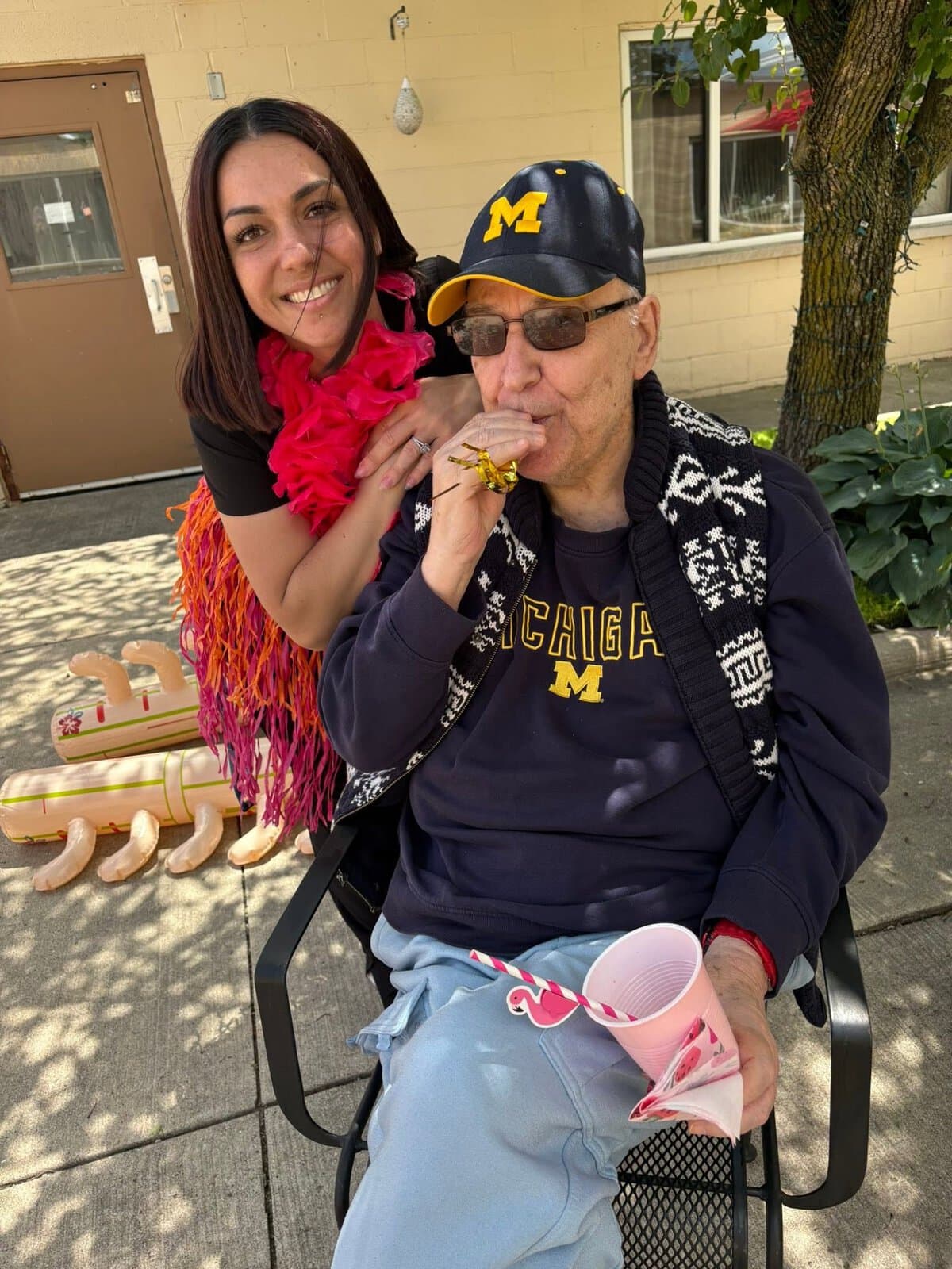 Cedar Woods staff member spending time with a resident outdoors in Belleville, Michigan