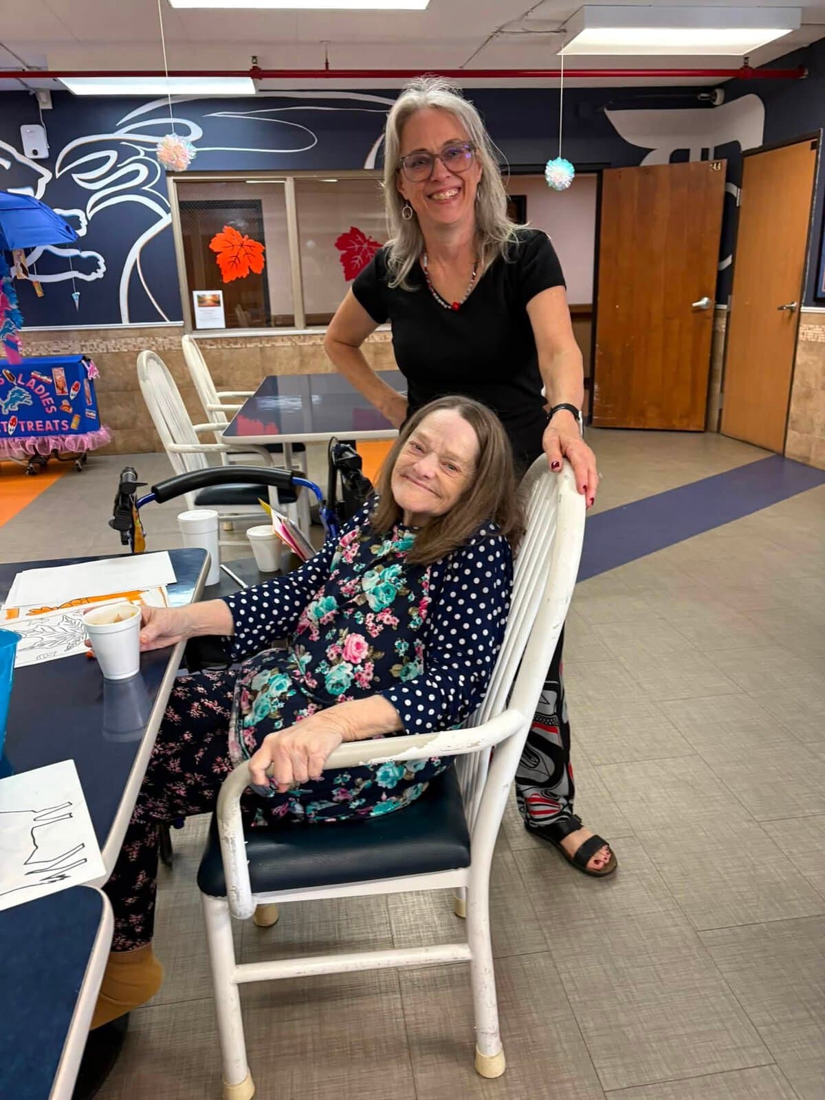 Cedar Woods resident sharing a warm moment with a staff member