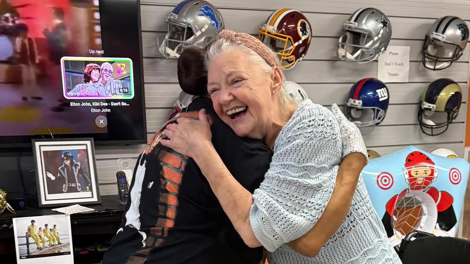 Cedar Woods resident laughing and sharing a hug during a community activity
