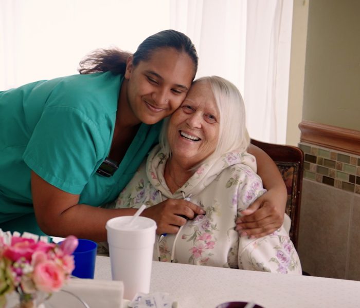 Cedar woods staff member hugging guest